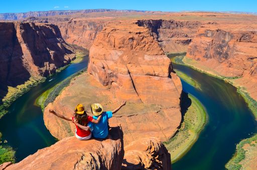 Two people enjoying the scenic Horseshoe Bend (Glen Canyon) in Page, Arizona, United States