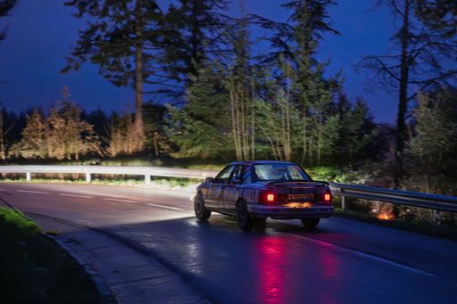 Ford Sierra Cosworth 4x4 201 competing in REG SPORT at Rally KH7 Costa Brava 2025, night scene, headlights on, rear view.