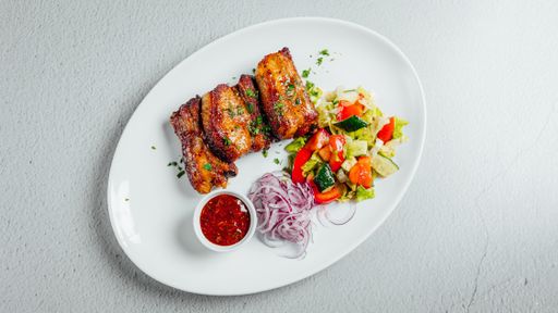 An overhead shot of a delicious meal with meat and salad