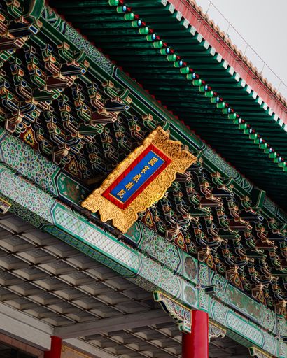 Intricate architectural details of a traditional Chinese temple ceiling with vibrant colors and patterns.