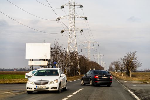 The cars transporting and merging on a long road in Targoviste, Romania