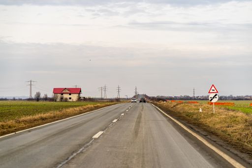 Several cars on the road in traffic in Targoviste, Romania captured from the windshield