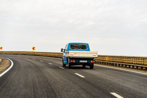 Several cars on the road in traffic in Targoviste, Romania captured from the windshield
