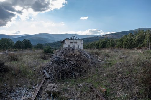 The ruins of an abandoned building in the garden under the blue sky