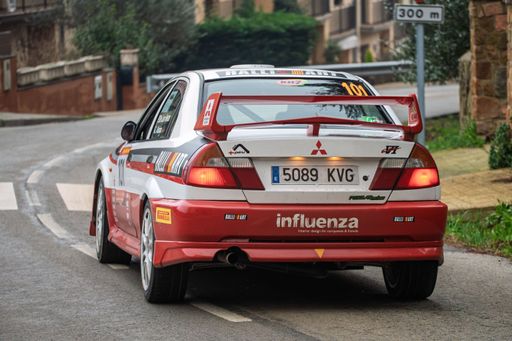 Rear view of Mitsubishi Lancer EVO VI rally car competing in the Rally 73 KH7 Costa Brava, Spanish Historic Rally Championship, in high-speed action.