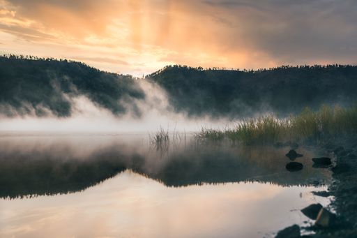 A river Reservoir - Greer Arizona during the morning golden hour fog over lake