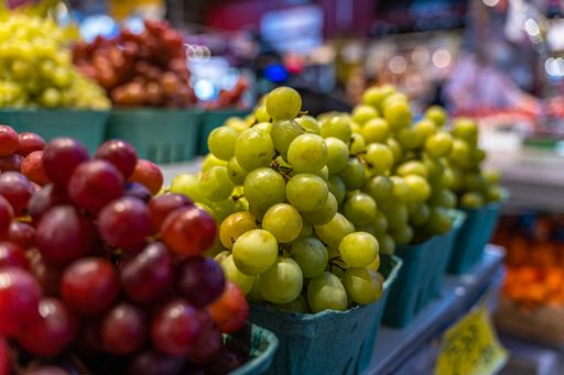 A selective focus shot of colorful grapes in a market at the Granville Island in Vancouver, Canada