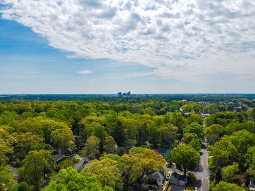 Aerial view of Greenboro skyline, including trees, streets and buildings