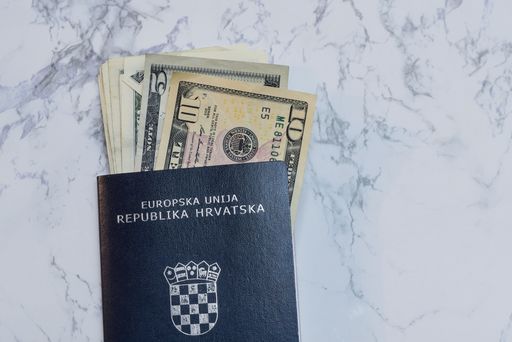 A closeup of dollars in a Croatian Passport on the table under the lights - money concept