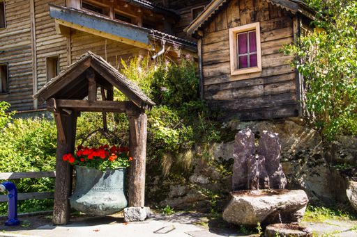 The beautiful rural shot of a wooden house and a small garden