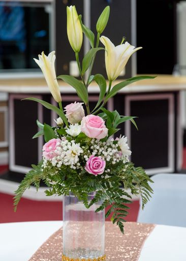 A vertical shot of a bouquet in a vase on the table