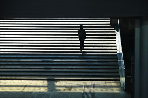 A high angle view of a human silhouette exiting from the underpass