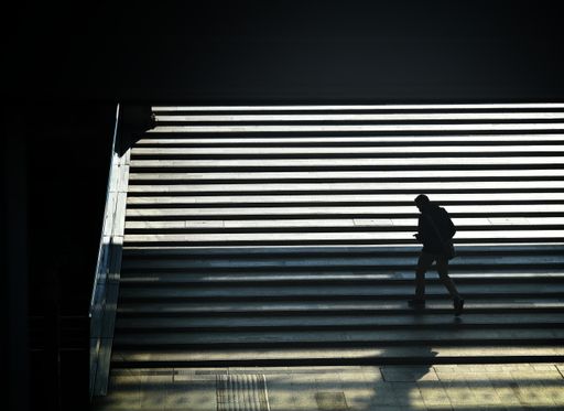 A high angle view of a human silhouette exiting from the underpass