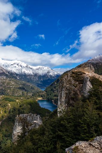 A beautiful view of a small lagoon between hills and forests