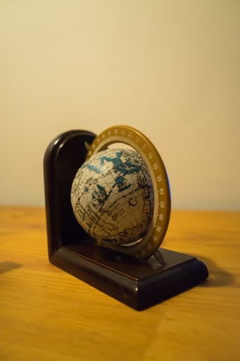 A vertical shot of a spinning globe on the table