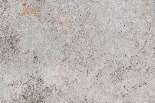 A top-down view of the dirty concrete flooring surface as background