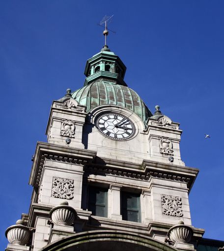 A low angle shot of an old clock tower against the blue sky in Vancouver, British Columbia, Canada