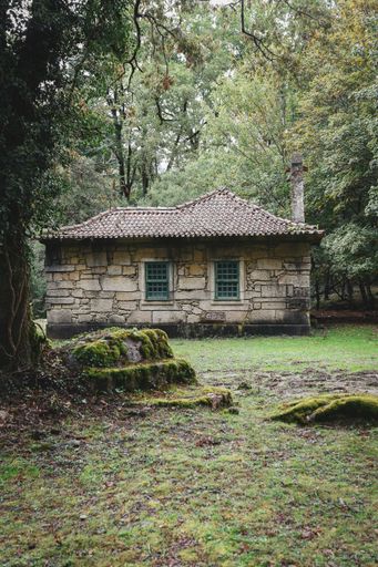 A vertical shot of an aged house surrounded by trees in Peneda-Geres National Park in Portugal