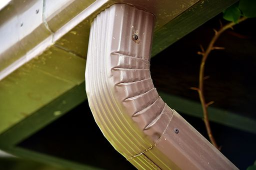 An elbow connection between a rain spout and the down spout.
