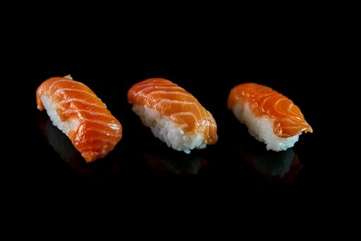 A closeup shot of raw fish sashimi isolated on black background
