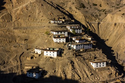 The Himalayan village of Dhankar with houses spread on a steep dry mountain slope in the Spiti valley in Himachal Pradesh, India.