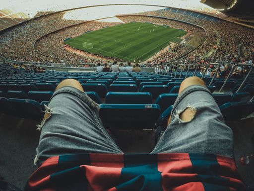 The fan legs with football stadium on the background