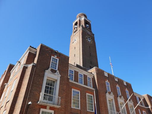 A low-angle shot of Barking Town Hall municipal building against a blue sky on a sunny day