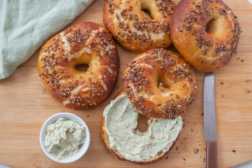 A top view of whole grain bagels with cream cheese