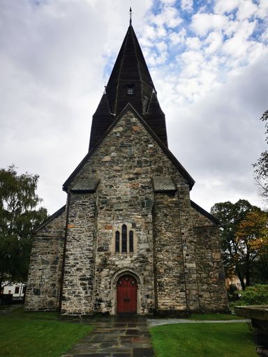 A vertical shot of old Voss church with background of the sky.