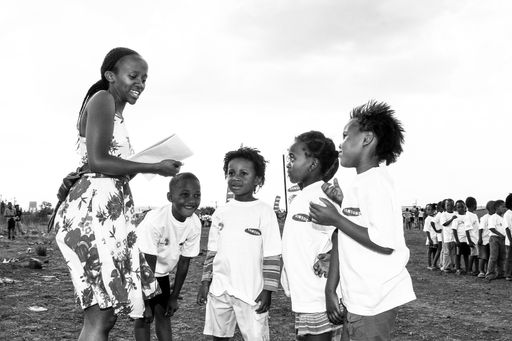 Johannesburg, South Africa - October 21, 2008: Volunteer Soccer coach working with young African children on a school playground