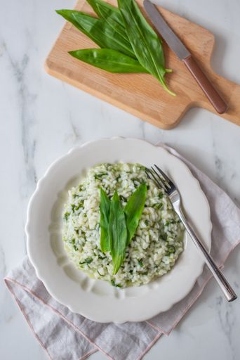 A top view of risotto with asparagus and wild garlic