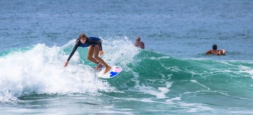 A surfer catching the wave at Mole Beach on the island of Santa Catarina