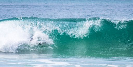 A person surfing at Mole Beach on the island of Santa Catarina, Florianopolis, Brazil