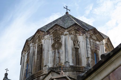 A low angle shot of an old church with sculpting in Armenia