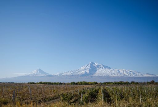 A beautiful shot of the mountain Ararat in the distance under a blue sky in Armenia
