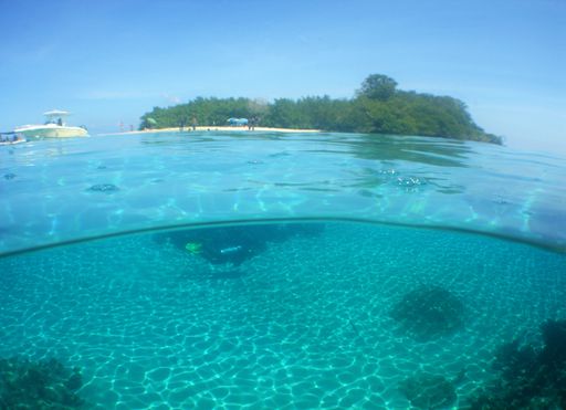 A beautiful image of the sea surface with a green island in the background