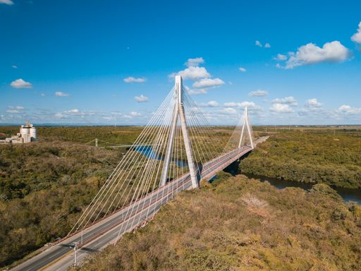 The Mauricio Baez Bridge surrounded by greenery on a sunny day in the Dominican Republic