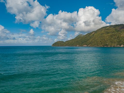 A landscape of El Valle Beach surrounded by greenery and sea in Samana, the Dominican Republic