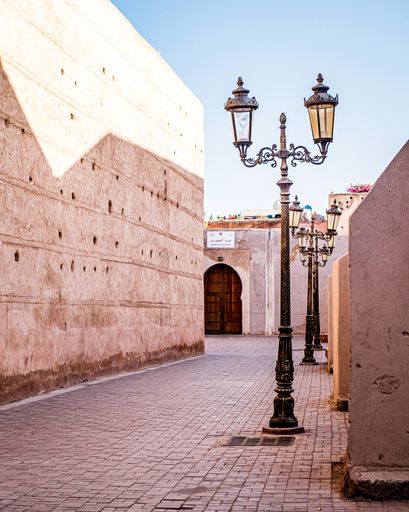 A vertical shot of a tall metal lamp surrounded by buildings