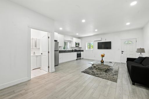 Charming single-level home featuring large pool, mature trees, mountain views, spacious interiors, and covered outdoor seating.
