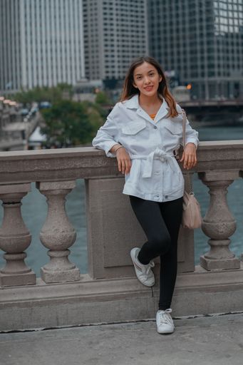 A vertical shot of a Caucasian (white) girl posing for the camera outside in United States