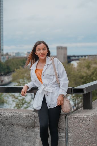 A vertical shot of a Caucasian (white) girl posing for the camera outside in United States