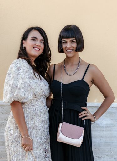 A vertical shot of two Caucasian (white) ladies posing and smiling to the camera in Croatia