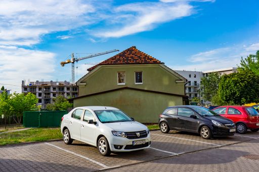 Parked cars on parking places in front of a green house in the Stare Zegrze district, Poznan, Poland