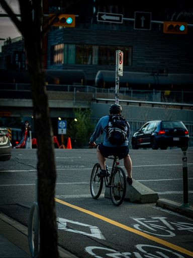 A man on his bicycle in the bike line waiting for the green light in downtown Calgary, Alberta
