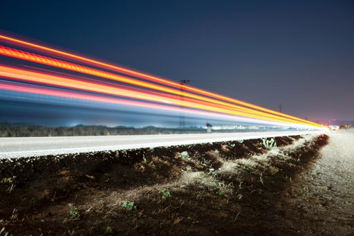 Night road lights. Lights of moving cars at night. long exposure red, blue, orange, multicolored, copy space