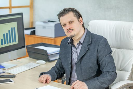 A young businessman working from his office  - the concept of confidence and success