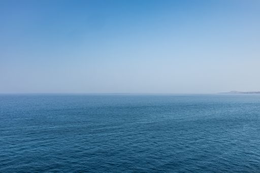 The calm endless sea under the blue sky