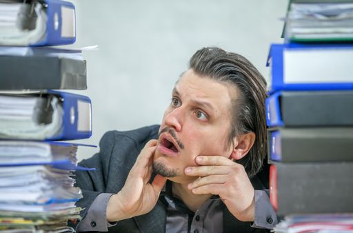 A young businessman working from his office - the concept of stress