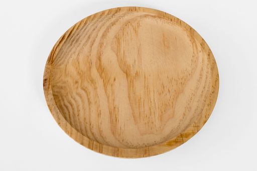 A round wooden tray isolated on a white background